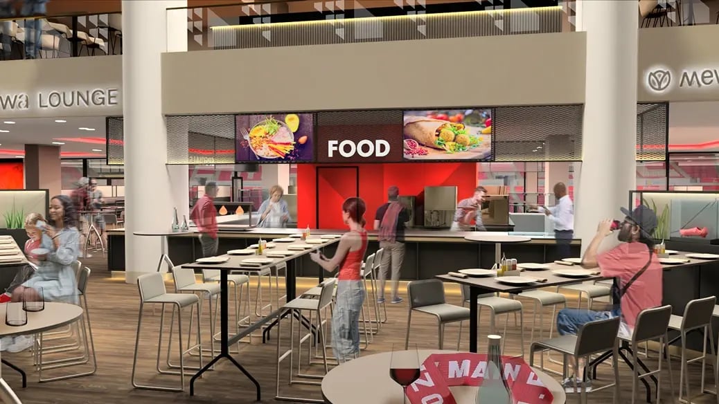 Der zentrale Food Cube in der MEWA ARENA bietet frisch zubereitete Speisen wie Grillgerichte und Wok-Spezialitäten in moderner Atmosphäre, mit Gästen, die das kulinarische Erlebnis genießen.